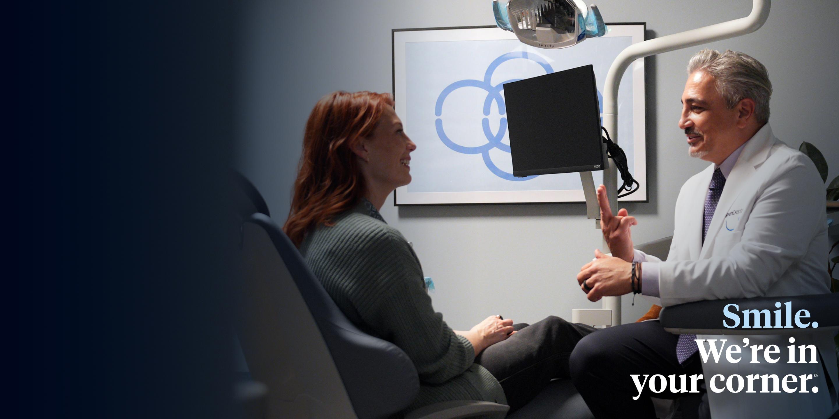 An Aspen Dental emergency doctor speaks with a patient. 