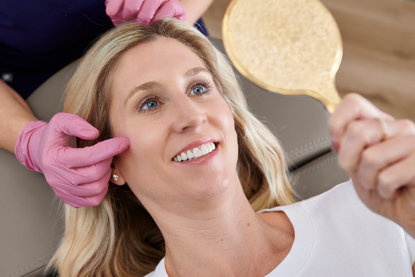Woman at her Botox appointment being professionally consulted on her treatment area at Chapter.