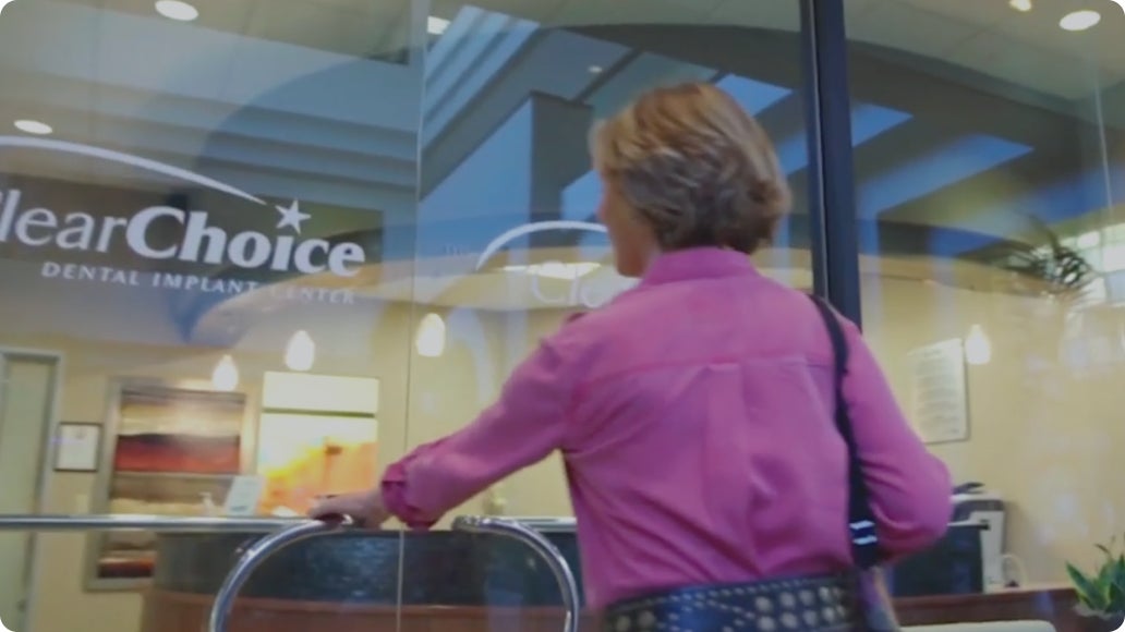 A woman walking into a ClearChoice office. 