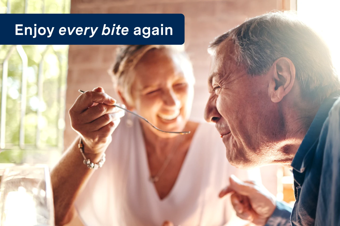 An older couple enjoying a meal together, savoring each bite, with the words "enjoy every bite again" on the image.