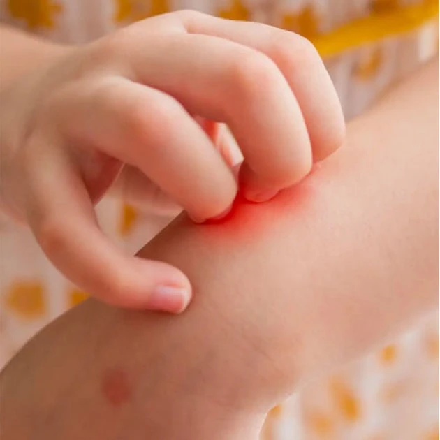 A person is scratching their arm with their hand