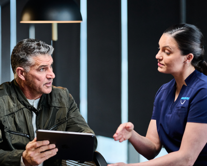 An Aspen Dental doctor explains the implant process to a patient. 