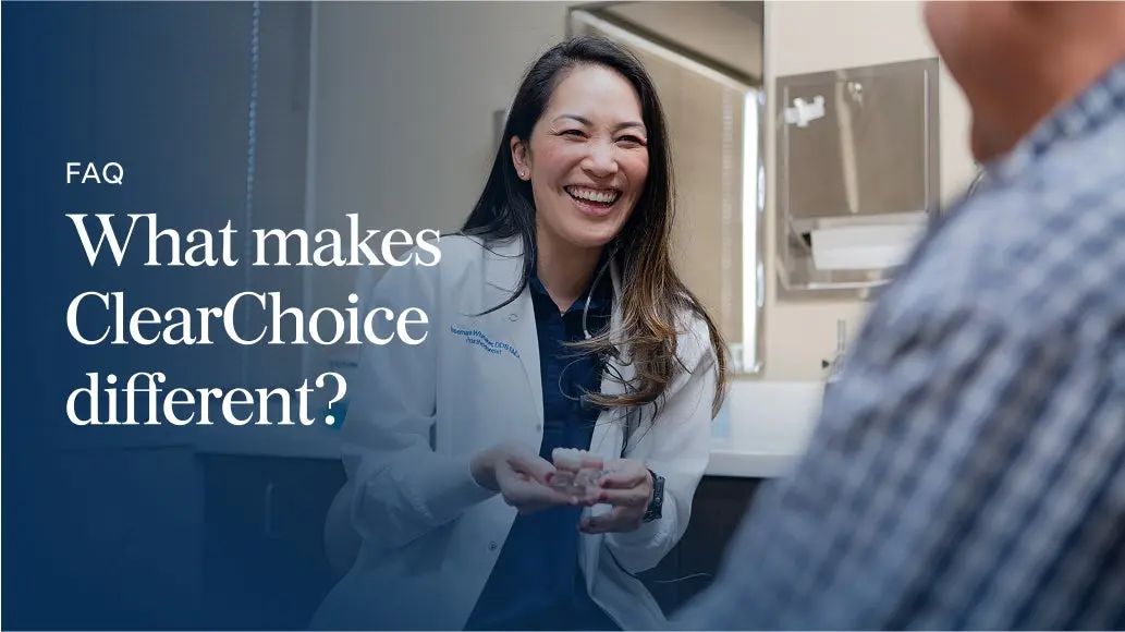 A ClearChoice dental specialist smiling and explaining treatment options to a patient, highlighting what makes ClearChoice different in a professional clinic setting.