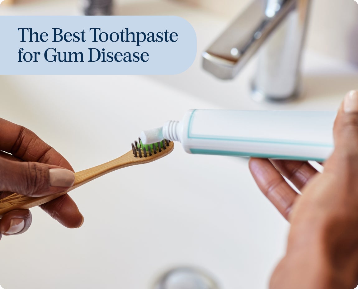 Hand applying toothpaste onto a bamboo toothbrush, focusing on dental hygiene products recommended by ClearChoice for effective gum disease management.