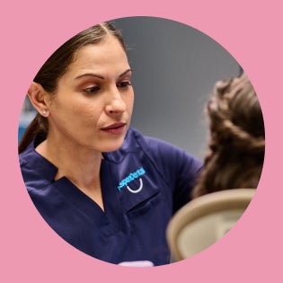 Dental professional discussing orthodontic treatment options with a patient in the clinic.