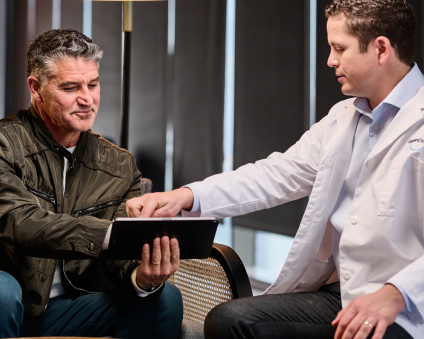 An Aspen Dental doctor and patient consult with one another. 