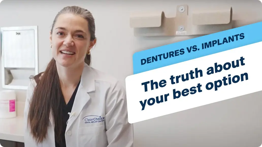 A woman in a lab coat is talking about dentures vs. implants, the truth about your best option. 