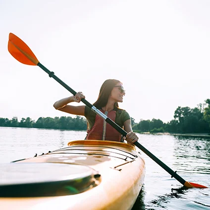 A young woman kayaking.