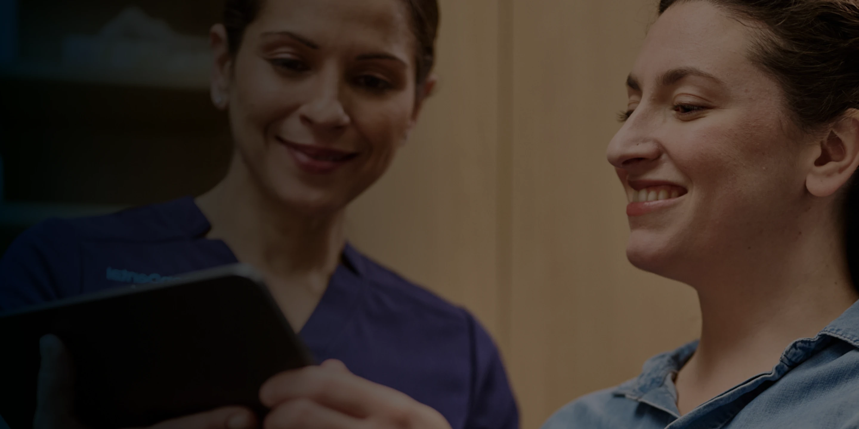 An Aspen Dental doctor consults with a patient. 