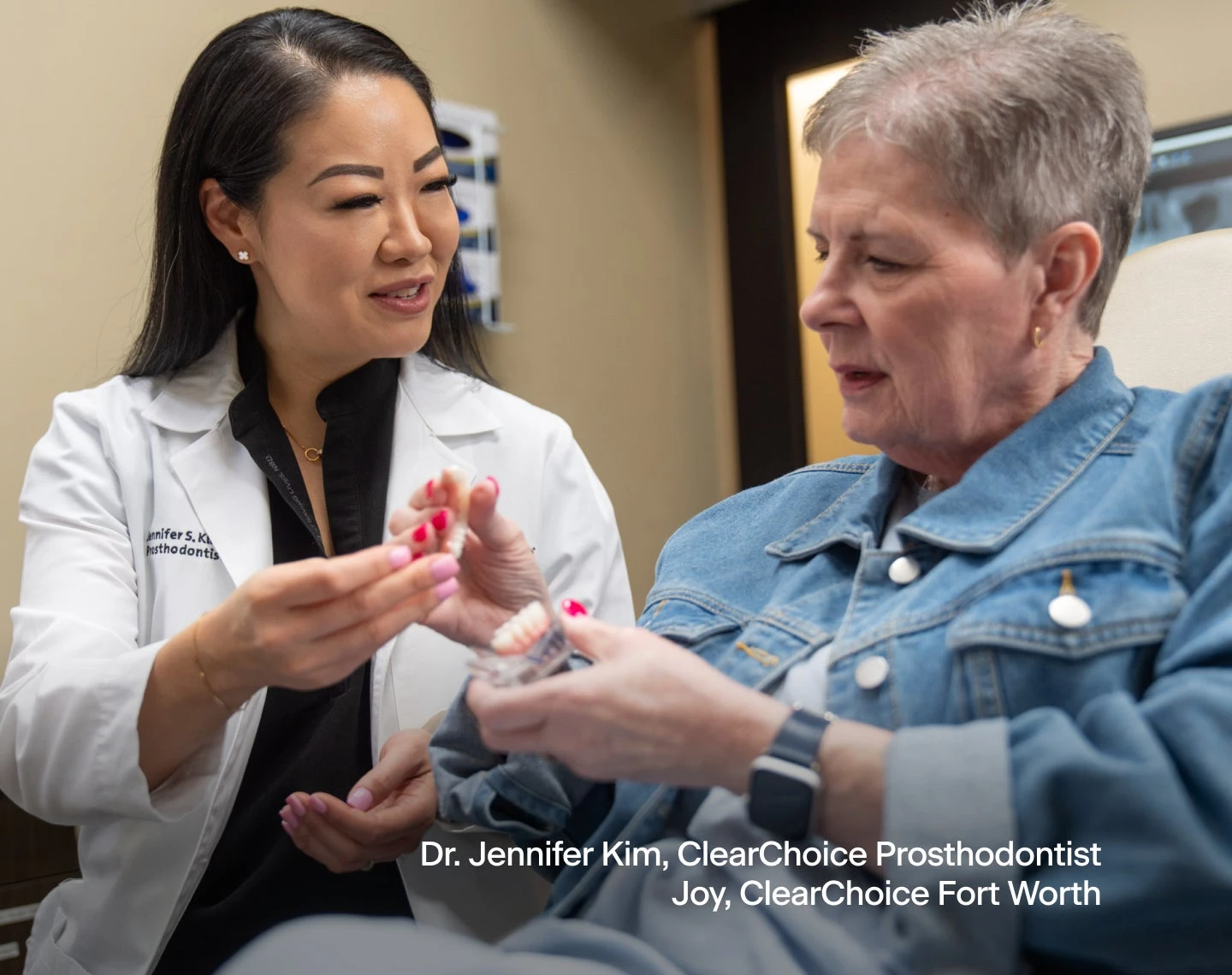 A doctor is talking to a patient who is sitting in a chair