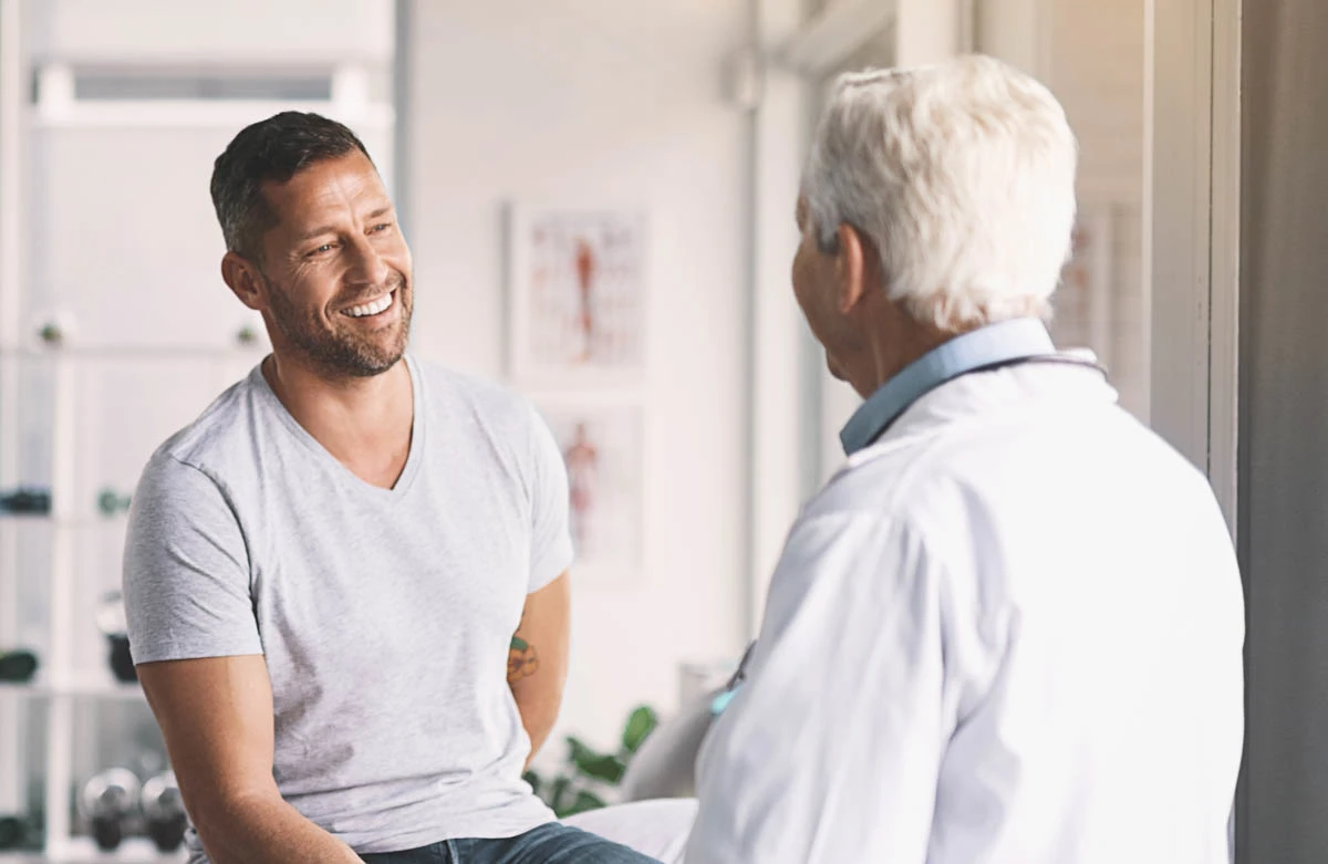 A WellNow doctor shakes hands with a patient.