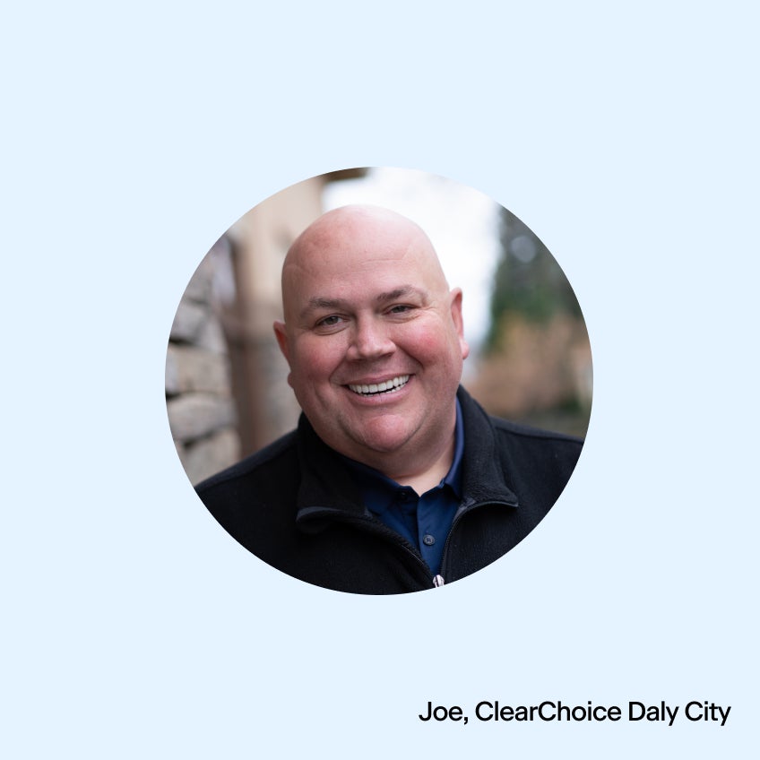 An image of a bald man smiling.