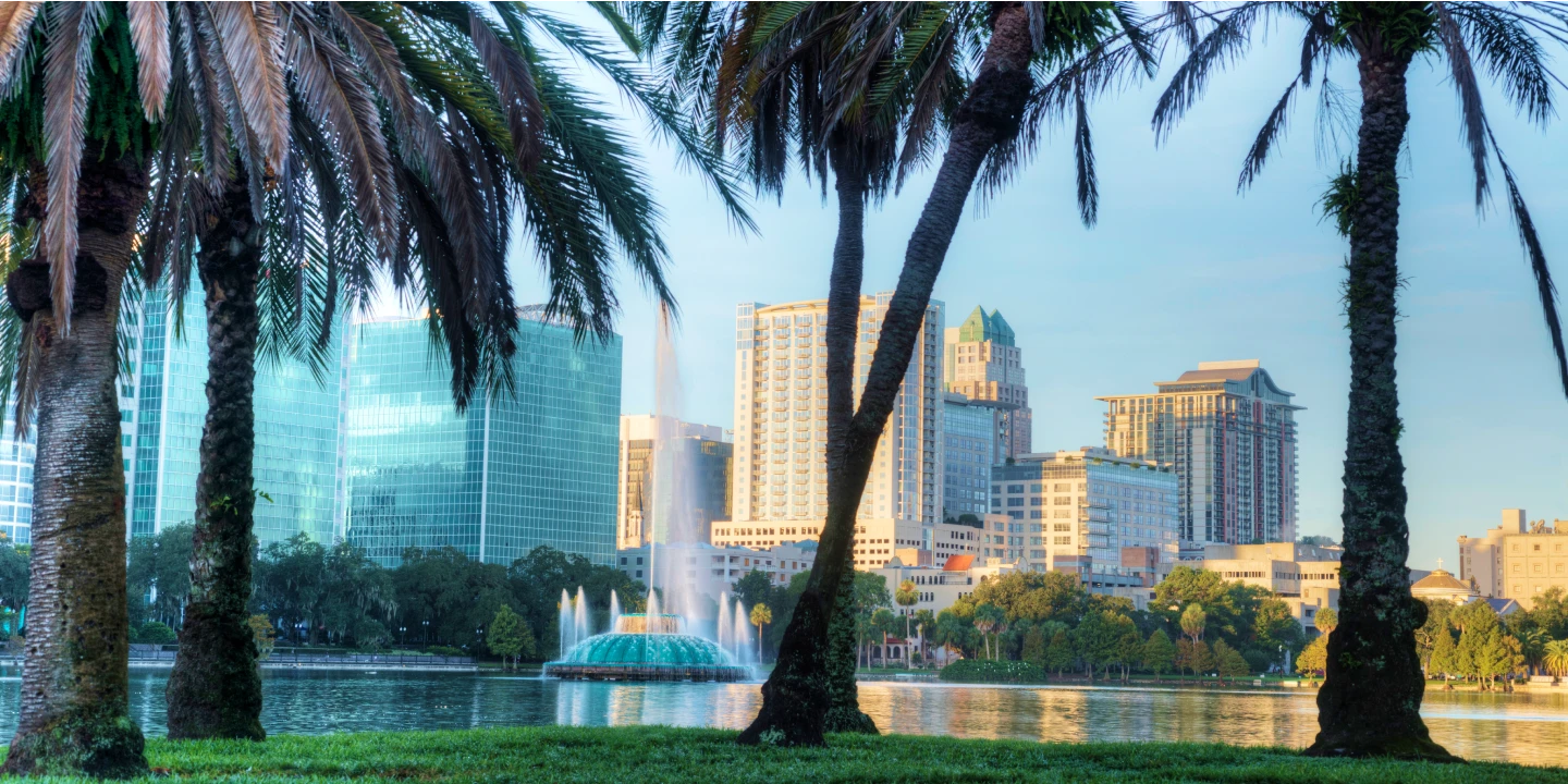 The Orlando skyline behind palm trees. 