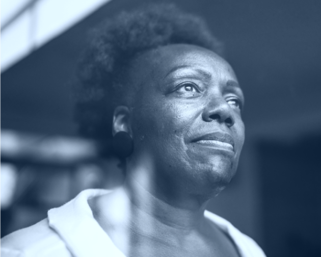 Black and white image of a contemplative senior woman gazing into the distance.