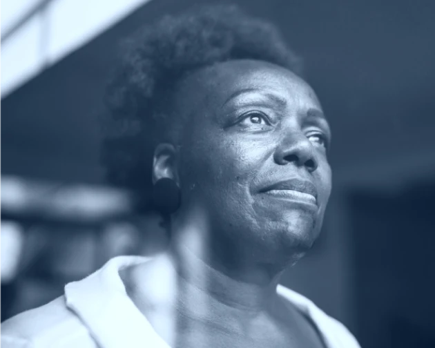 Black and white image of a contemplative senior woman gazing into the distance.