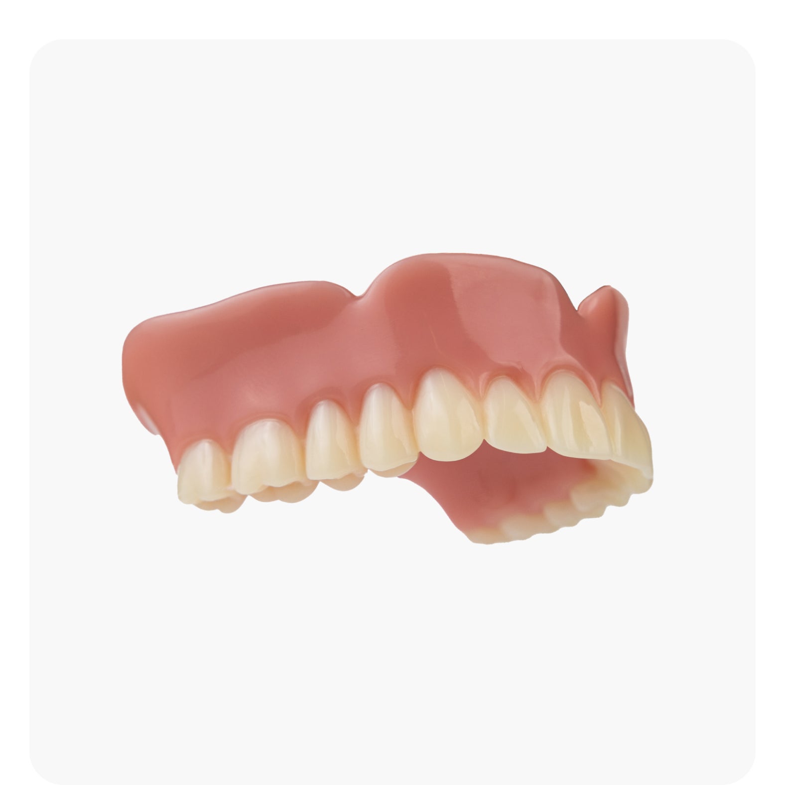 Side-angle view of Aspen Dental’s basic dentures highlighting the natural tooth shape and gum design for a comfortable fit.