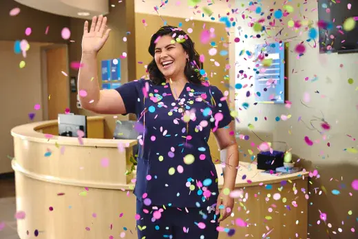 Motto Clear Aligners technician waving with confetti falling all around her.