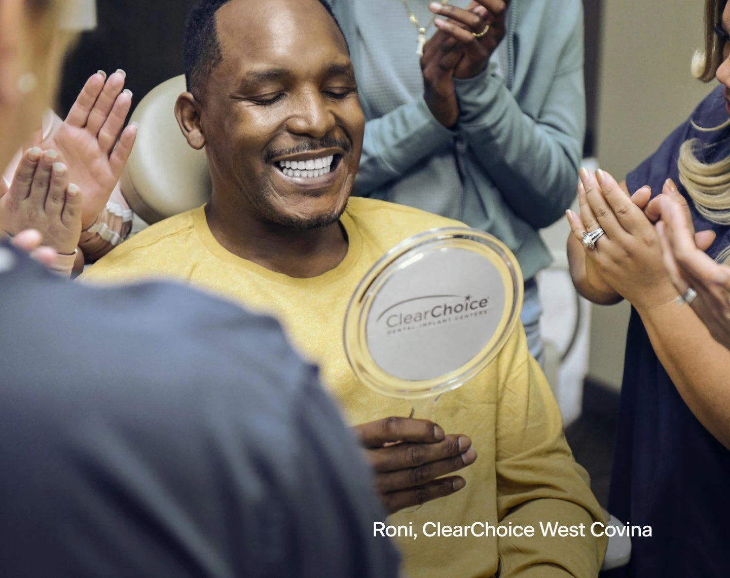 A man is smiling in front of a clear choice mirror