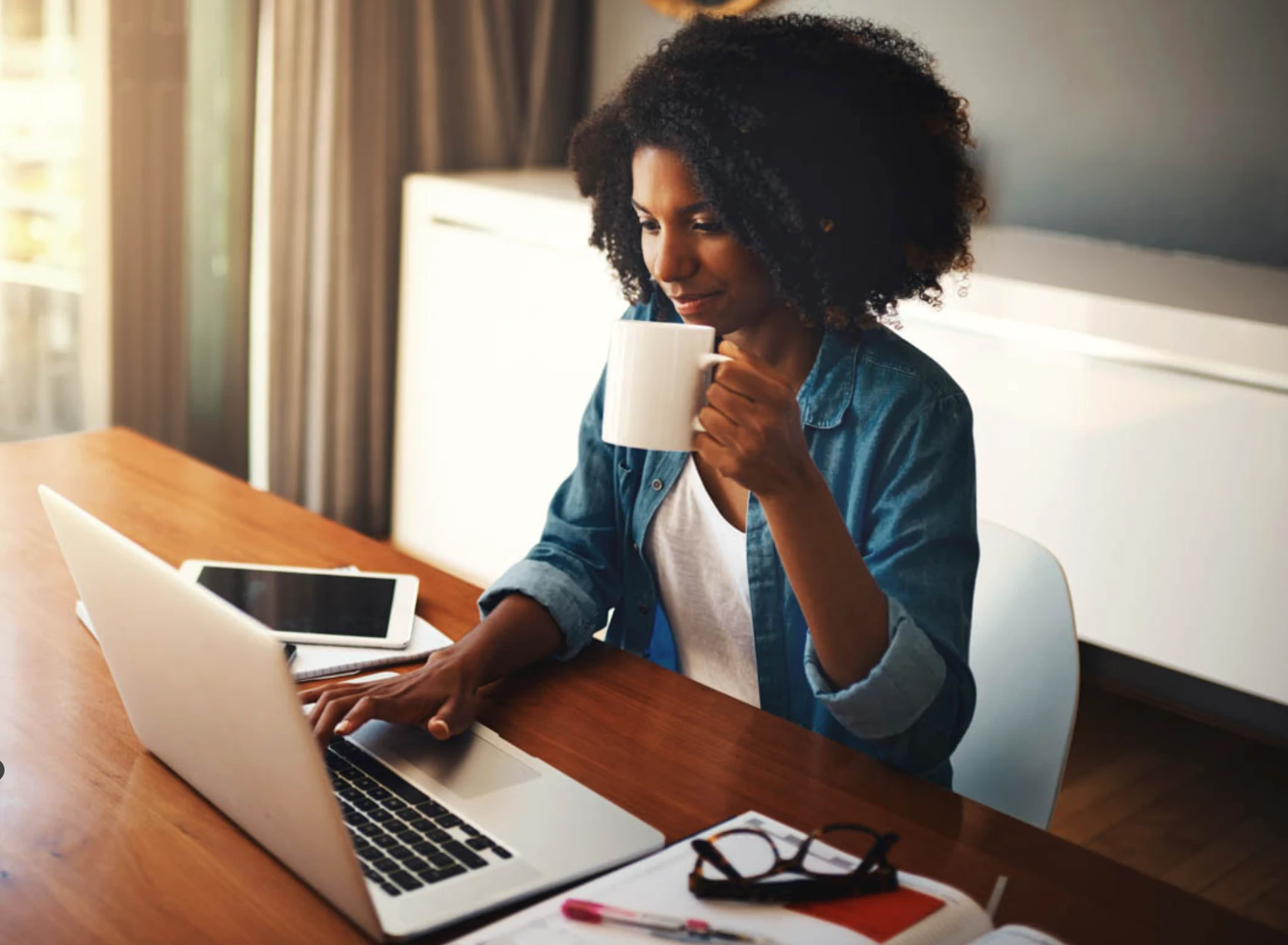 A woman schedules a WellNow appointment on her laptop.