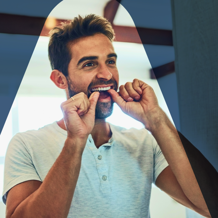 A man flossing his teeth to prevent various gum-related issues, including gingivitis with red, swollen gums, and periodontitis.