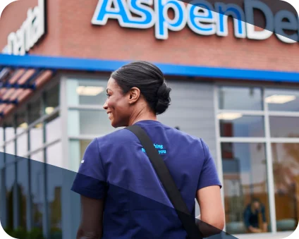 An Aspen Dental doctor walks into a dental office. 