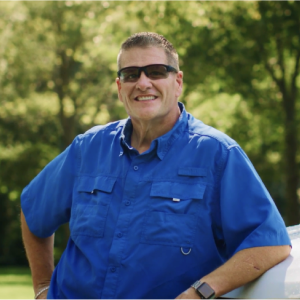 Garry poses for a photo while wearing sunglasses.