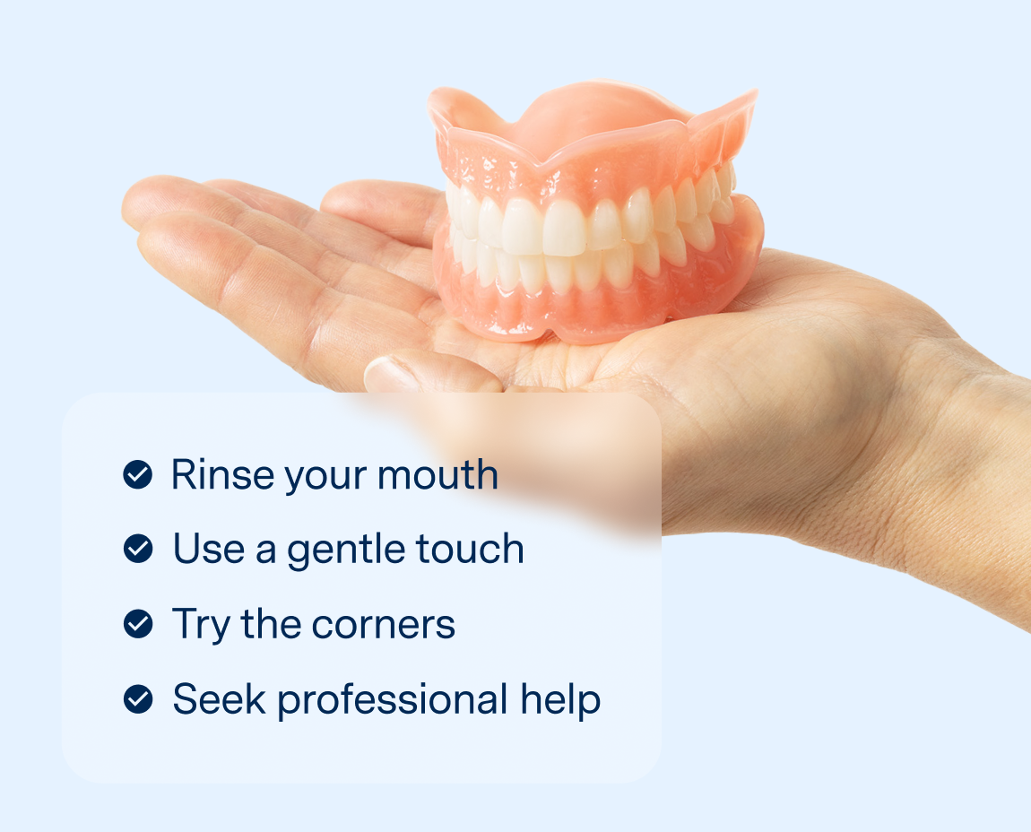 Hand holding a set of dentures with a list of tips for removing dentures, including rinsing, gentle touch, and seeking professional help.