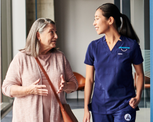 An Aspen Dental doctor speaks with a patient. 