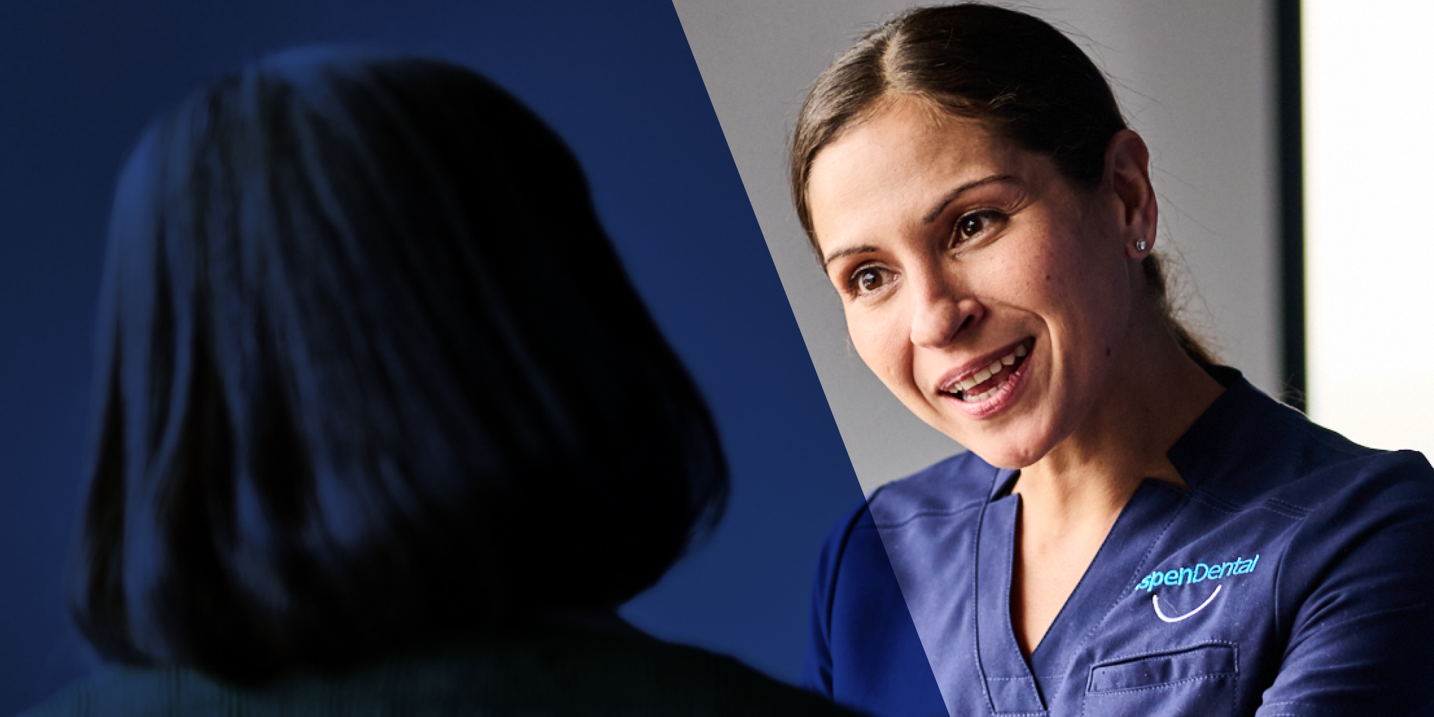 An Aspen Dental doctor speaks with a patient. 