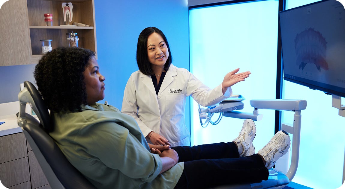 A ClearChoice doctor discussing possible treatment options and procedures with the patient based on her current teeth conditions.