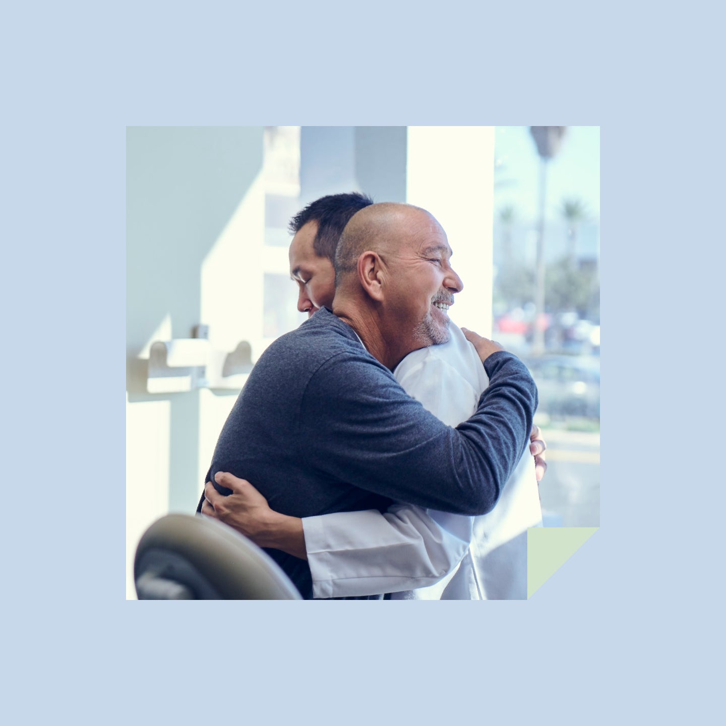 A male patient hugging his male dentist.