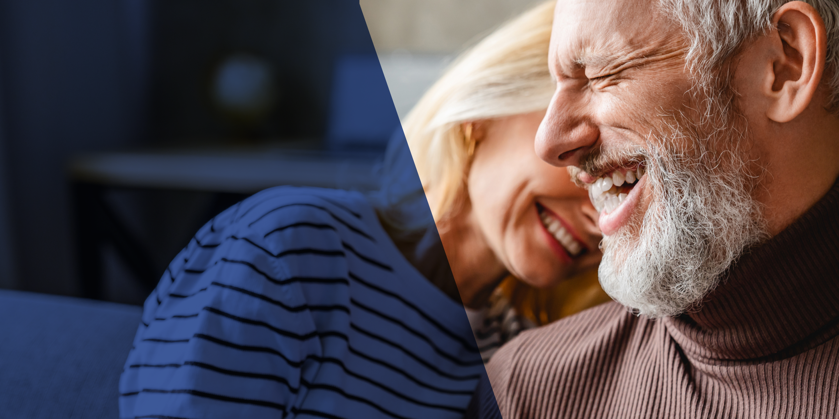 A middle-aged couple laughs with one another. 