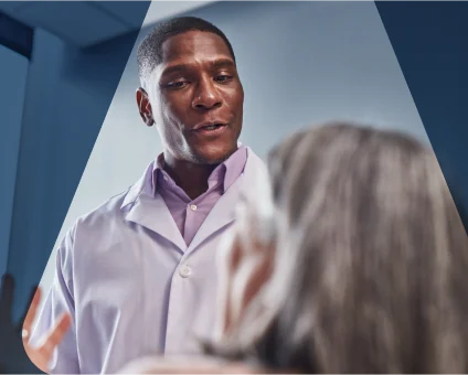 Dentist reviews patient's dental X-rays for comprehensive oral examination.