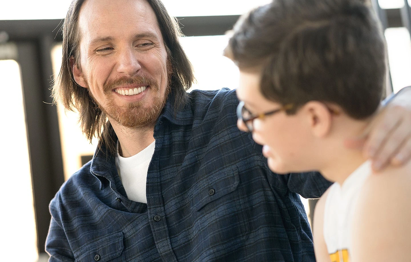 Smiling ClearChoice dental implants patient spending time with their son. Represents improved quality of life after treatment.