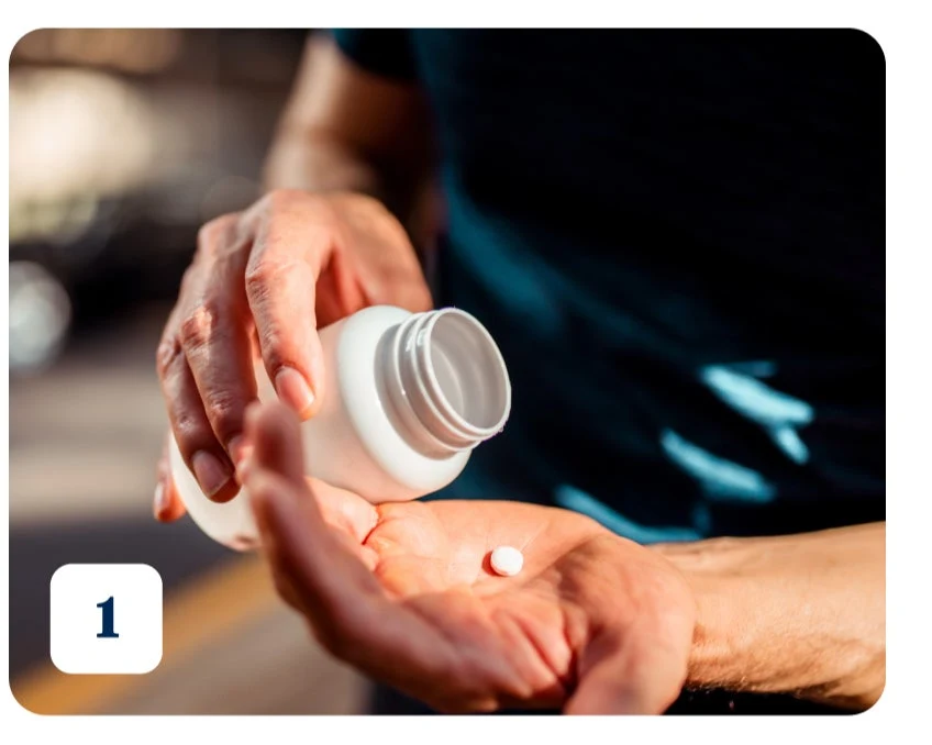 A person wearing dark green t-shirts pouring a white pill from a white bottle into their hand. The number "1" is written on the bottom left corner indicating the first treatment option for dental abscess.