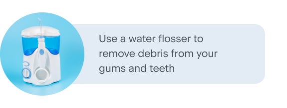 A water flosser with a blue water reservoir, displayed on a light blue background. The text next to the image recommends using a water flosser to remove debris from teeth and gums, promoting better oral hygiene.