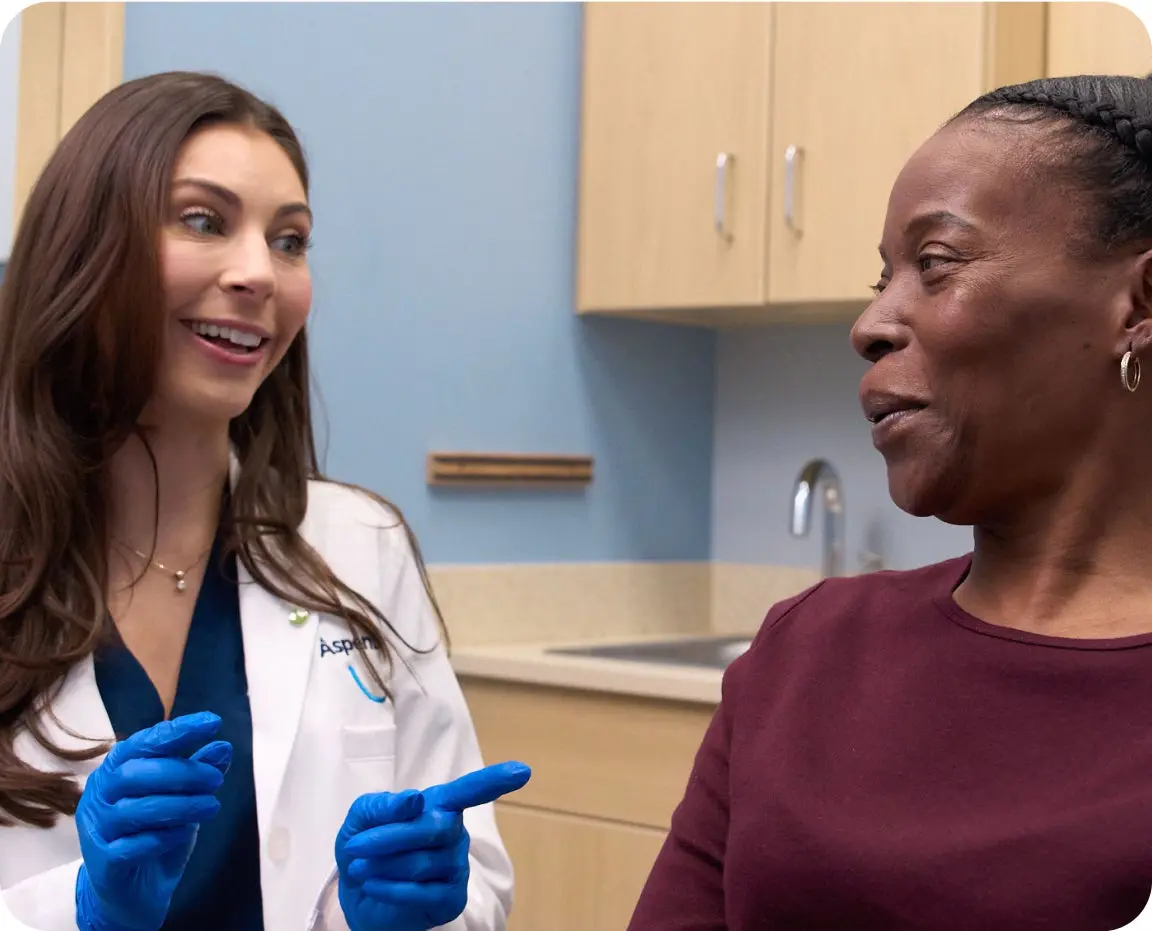 A dental professional discusses symptoms with a patient, helping to distinguish between cold sores and canker sores through patient consultation.