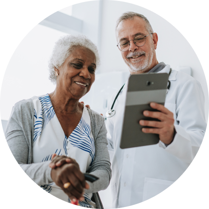 A WellNow doctor consults with a patient with a tablet in hand. 