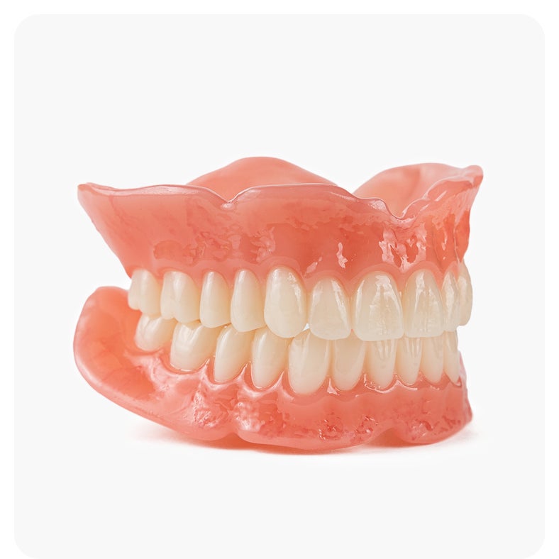 Full set of Aspen Dental signature dentures with natural gum and tooth appearance