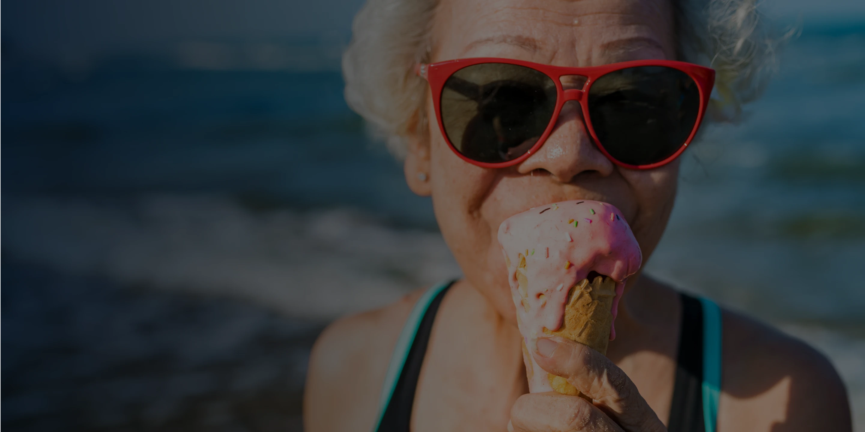 An Aspen Dental dentures patient eats an ice cream cone. 