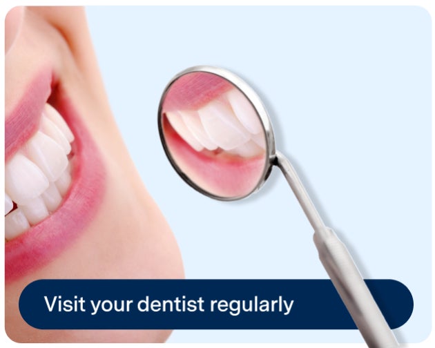  Close-up of a person's smile being examined with a dental mirror. The image includes text that reads, "Visit your dentist regularly.