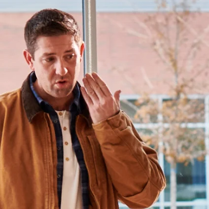 An individual experiencing a dental emergency, with his hand close to his cheek, indicative of intense toothache and severe oral discomfort.