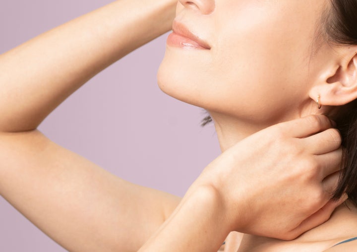 Close-up of a woman and her neck, hands and arms, representing the Radiesse treatment on the Chapter Aesthetic Studio website.