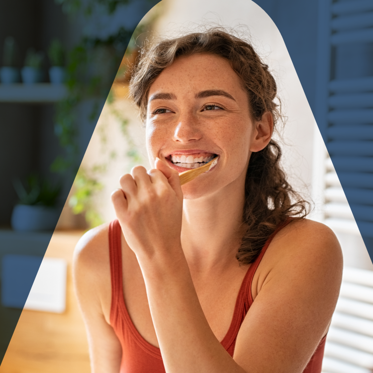 A woman brushing teeth to prevent common dental issues such as cavities, gum redness, plaque buildup, and misaligned teeth, highlighting the importance of oral hygiene and regular dental check-ups.