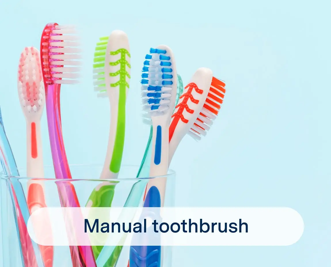 Several colorful manual toothbrushes are arranged vertically in a clear glass against a light blue background. The text "Manual toothbrush" is displayed at the bottom.