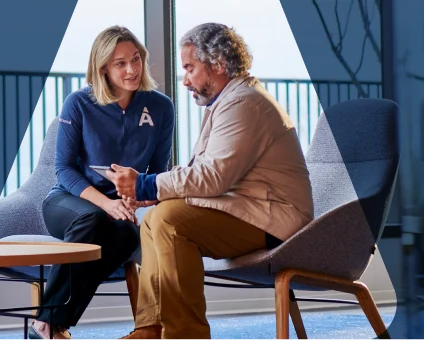 Dental consultant discussing treatment plan with patient after reviewing dental X-rays for comprehensive oral care.