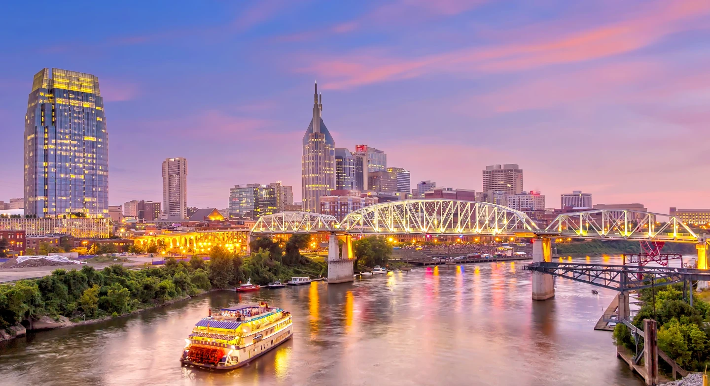A view of the Nashville skyline and the river at sunset