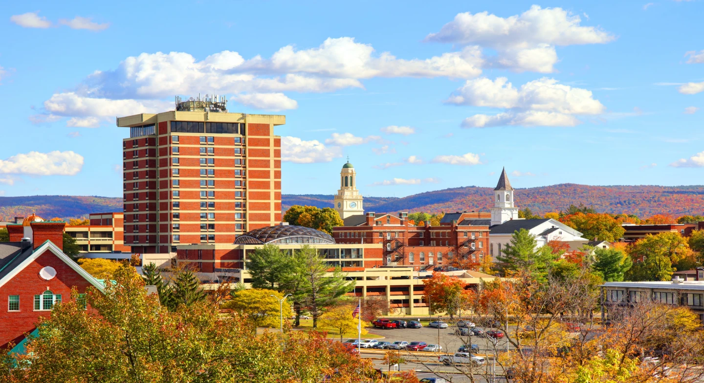 A view of buildings in Massachusetts surrounded by fall foliage