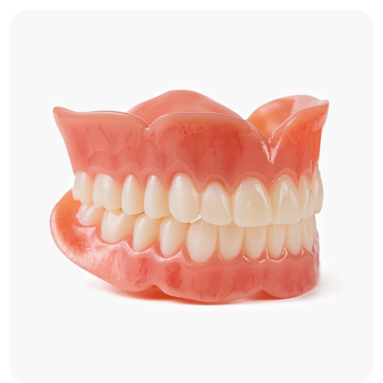 Classic dentures with natural-looking teeth and pink gums, provided by Aspen Dental.