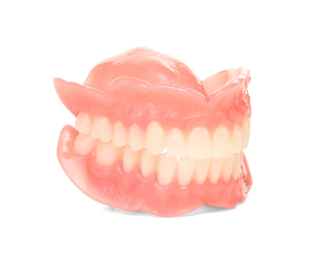 Comfilytes full dentures with a complete set of white teeth, pink gums, on white background.